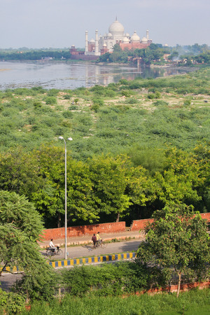 AGRA, INDIA - SEPTEMBER 21, 2008: Unidentified people passing by a street near the Taj Mahal, the "jewel of Muslim art in India", white marble mausoleum in Agra, Uttar Pradesh, Indiaのeditorial素材