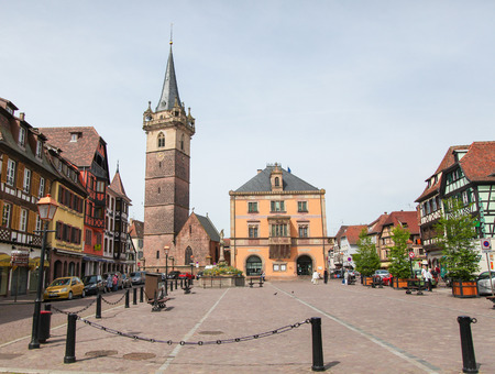 OBERNAI, FRANCE - MAY 11, 2015: Chapel tower, Sainte Odile fountain and town hall on the market square of Obernai, Bas-Rhin, Alsace, Franceのeditorial素材