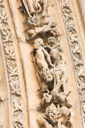 LEON, SPAIN - AUGUST 12, 2014: Sculptures of People and Devils in Hell in the Cathedral of Leon in Castile and Leon, Spain.のeditorial素材
