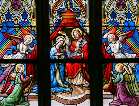 PRAGUE, CZECH REPUBLIC - APRIL 5, 2016: Stained Glass in the Basilica of Vysehrad in Prague, Czech Republic, depicting Christ placing a crown on the head of Mary as Queen of Heavenのeditorial素材