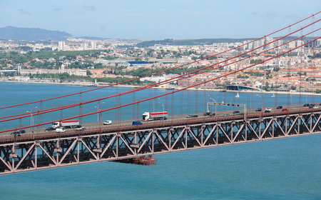 Ponte 25 de Abril across the Tagus river and view on the center of Lisbon, Portugalのeditorial素材