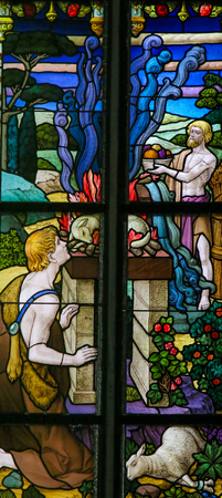 Stained Glass window depicting a sacrifice of lambs in the Cathedral of St Rumbold of Mechelen, Belgium.の写真素材