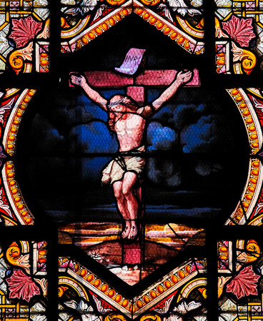 Stained Glass window depicting Jesus Christ on the cross in the Saint Sulpice church in Paris, created in the 17th Century.のeditorial素材