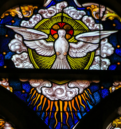 Stained Glass depicting the Holy Spirit as a Dove, in the Cathedral of Saint Bavo in Ghent, Belgium.のeditorial素材