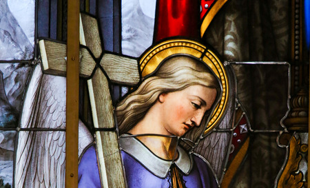 Stained Glass in Saint Nicholas Church, Ghent, Belgium, depicting an Angel carrying a Crossのeditorial素材