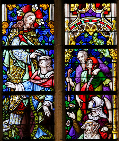 Stained Glass window depicting Healings by Jesus Christ in the Cathedral of Saint Bavo in Ghent, Flanders, Belgium.のeditorial素材