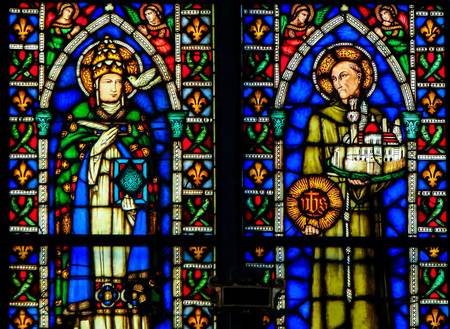 Stained Glass window in the Basilica of Santa Croce, Florence, depicting Catholic Saintsのeditorial素材