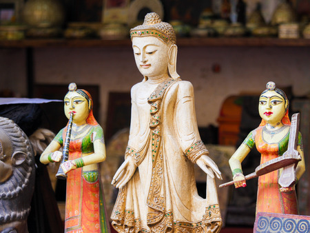 Statue of Buddha and two Indian Women on a souvenir market in Jaisalmer Fort in Rajasthan, India.のeditorial素材