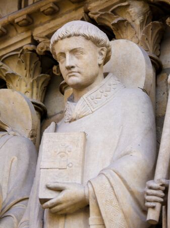 Medieval Statue of Saint Stephen at the Cathedral of Notre Dame, Paris, France.の写真素材