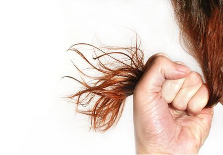 The woman holds the hair in a fistの写真素材