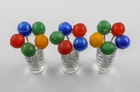 Colourful Lollipops arranged like Flowers in Glass Vase.