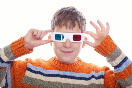Cute young boy wearing 3D glasses isolated over whiteの写真素材