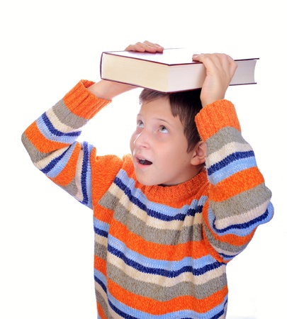 Student child with a book on his head isolated over whiteの写真素材