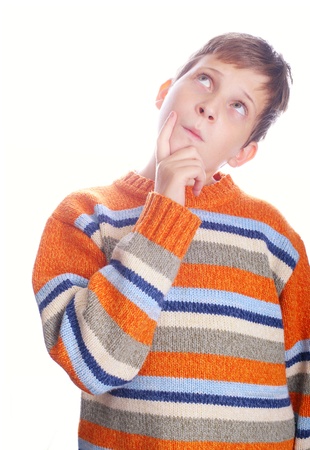 Pensive child with blond hair isolated on white background looking upの写真素材