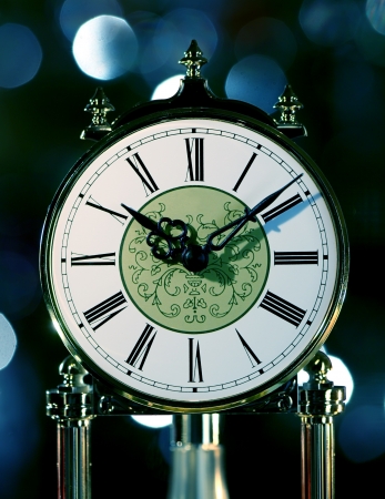 Moving old antique clock against abstract backgroundの写真素材