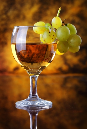 Glass of white wine with grapeの写真素材