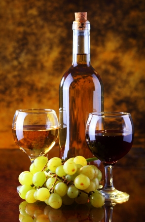 Wine composition with grape bottle and glass of red and white wineの写真素材