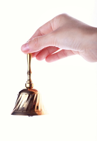 Hand hold handbell isolated on whiteの写真素材