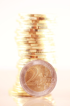 Coin pile with two euro isolated on white backgroundの写真素材