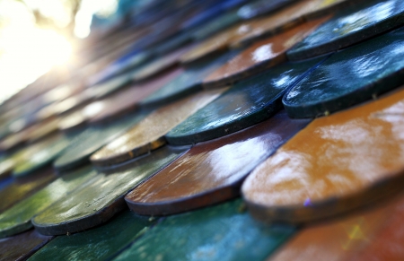 Colorful enamelled roof tile with sunshineの写真素材