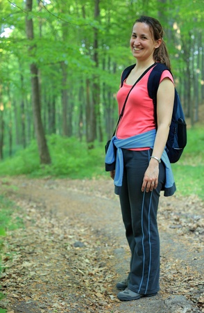 Young woman with backpack in a woodsの写真素材