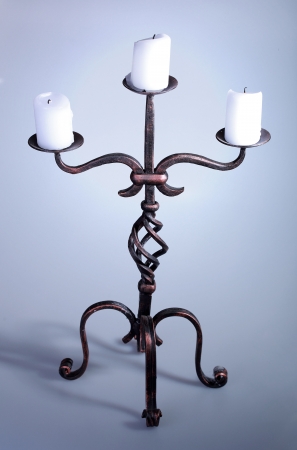 Tall iron candelabra with three candlesの写真素材