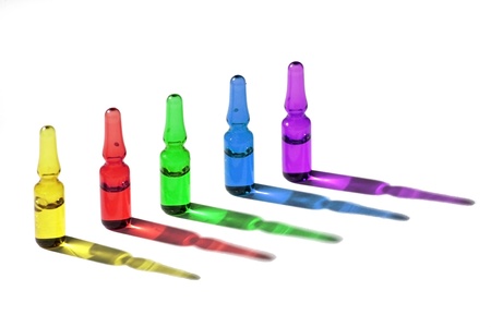 Five colorful medical phials are standing in queueの写真素材