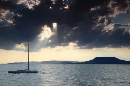 Lonely sailboat floating on Lake Balatonの写真素材