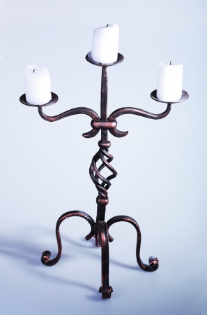 Tall iron candelabra with three candlesの写真素材