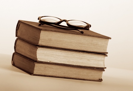 Three old book with eyeglassesの写真素材