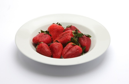 Beautiful strawberries in white plateの写真素材