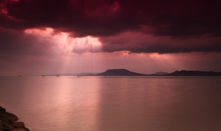 Dramatic sky with sunbeam over Lake Balaton in Hungaryの写真素材