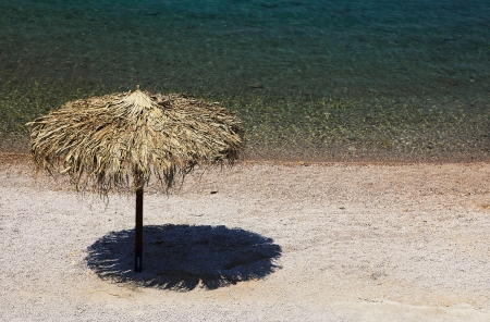 Beach umbrella from grass material on the beachの写真素材