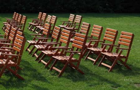 Wooden chairs on a nice green grass garden areaの写真素材
