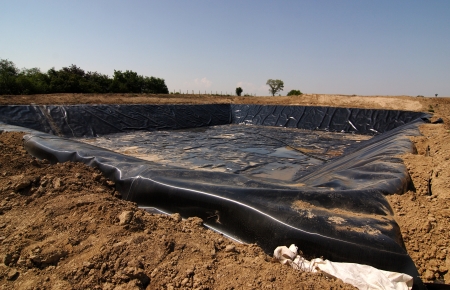Empty new landfill with plastic isolating layerの写真素材