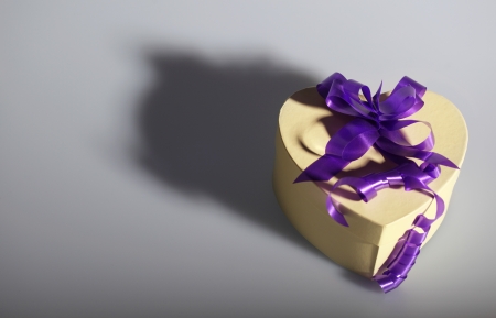 Heart shaped present box with ribbonの写真素材