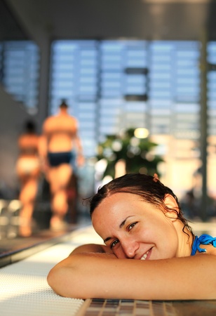 Woman at the edge of a swimming poolの写真素材