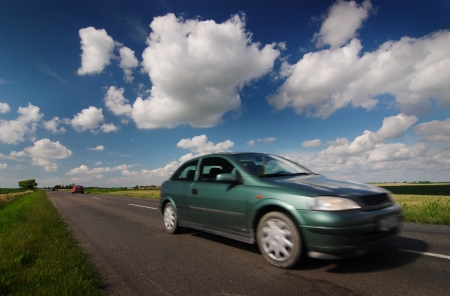 Car drive on road, blue sky with beautiful cloudsの写真素材