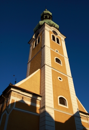 Yellow church tower against blue skyの写真素材