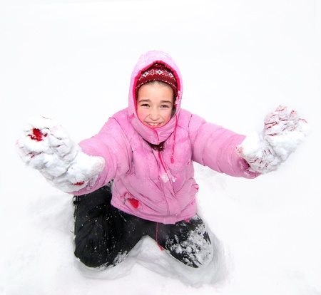 Nice girl kneel in snow and show her palmsの写真素材