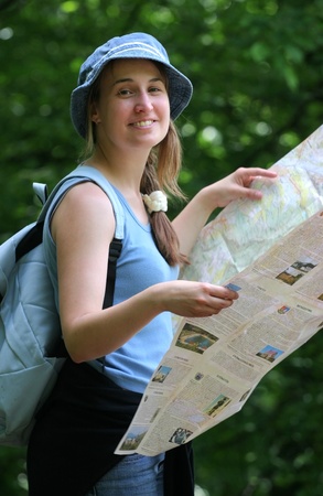 Female explorer looking at a map outdoors