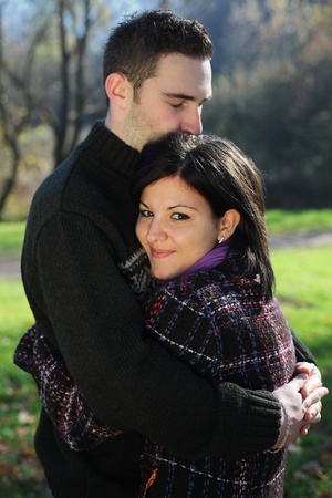 Portrait of romantic young couple in autumn outdoorの写真素材