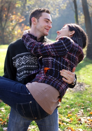 Portrait of romantic young couple in autumn outdoorの写真素材
