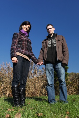 Portrait of romantic young couple in autumn outdoorの写真素材