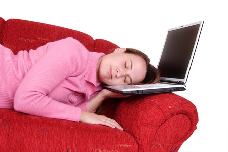 Young woman sleeping on the laptopの写真素材