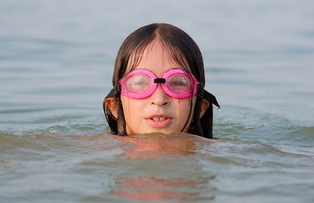 Young girl are swimming in a lakeの写真素材