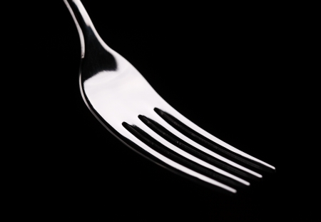 Empty fork on a black background