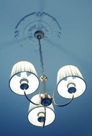 Vintage chandelier hanging from ceilingの写真素材