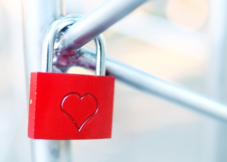 The closed red padlock with heartの写真素材