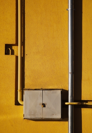 Propane gas supply pipe against stucco wallの写真素材